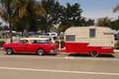 1964 Shasta Trailer being towed by a 1955 Chevy Nomad Station Wagon